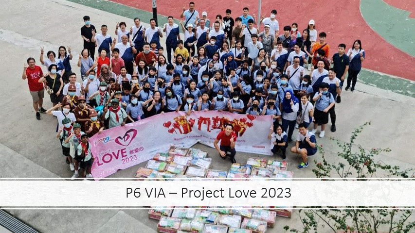 Large group of students and adults posing outdoors with a Project Love 2023 banner and stacked gift boxes.